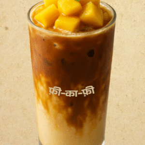 Iced Mango Bite Coffee featuring mango milk, bold espresso, and mango chunks, served in a clear glass.